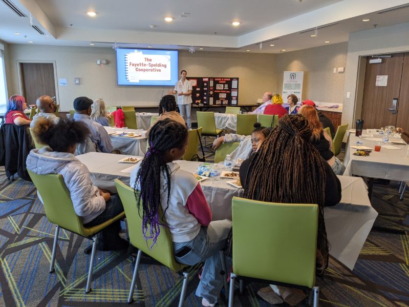 Zachery Fuller speaking to a crowd about the Fayette-Spalding Cooperative.